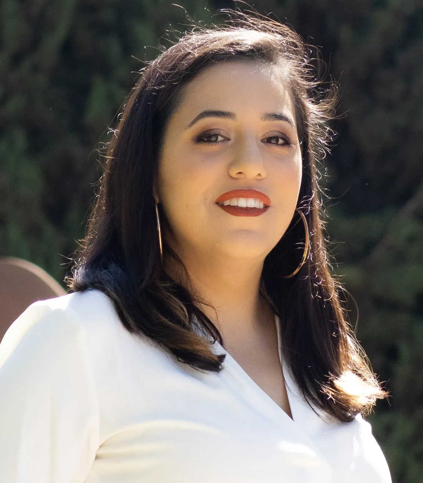 Nikki Perez beside an official ballot drop box in Burbank.